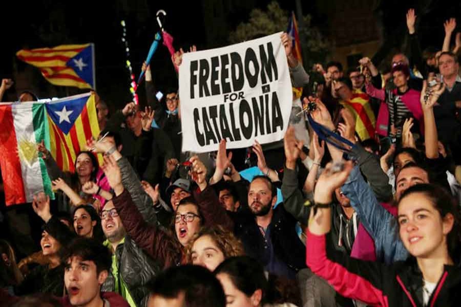 People react as they gather at Plaza Catalunya after voting ended for the banned independence referendum at Barcelona in Spain on Sunday. — Reuters