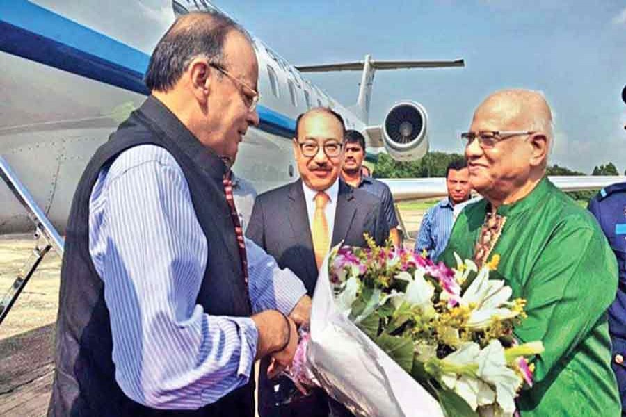 Finance Minister A M A Muhith receives his Indian counterpart Arun Jaitley on the latter's arrival in Dhaka on a three-day visit on Tuesday. — Collected