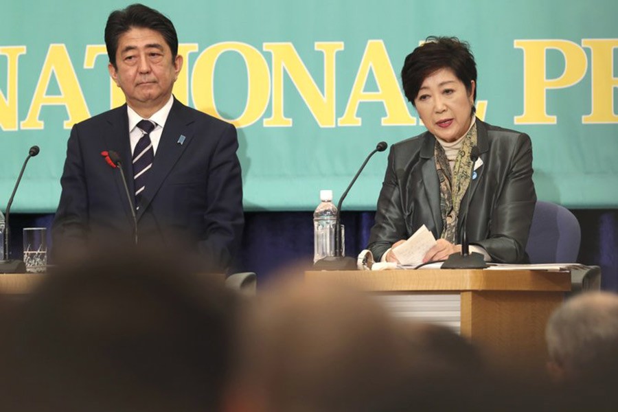 Party of Hope leader Yuriko Koike, right, speaks as Ruling Liberal Democratic Party leader and Japan’s Prime Minister Shinzo Abe listens during the party leaders’ debate in Tokyo on Sunday for lower house election. -AP Photo
