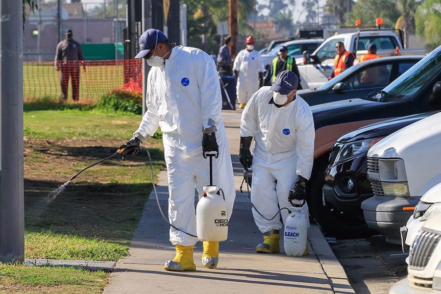 Work crews spray a bleach solution at North Park Community Park on October 13 as part of the battle against the hepatitis A outbreak in San Diego. Photo courtesy: Los Angeles Times