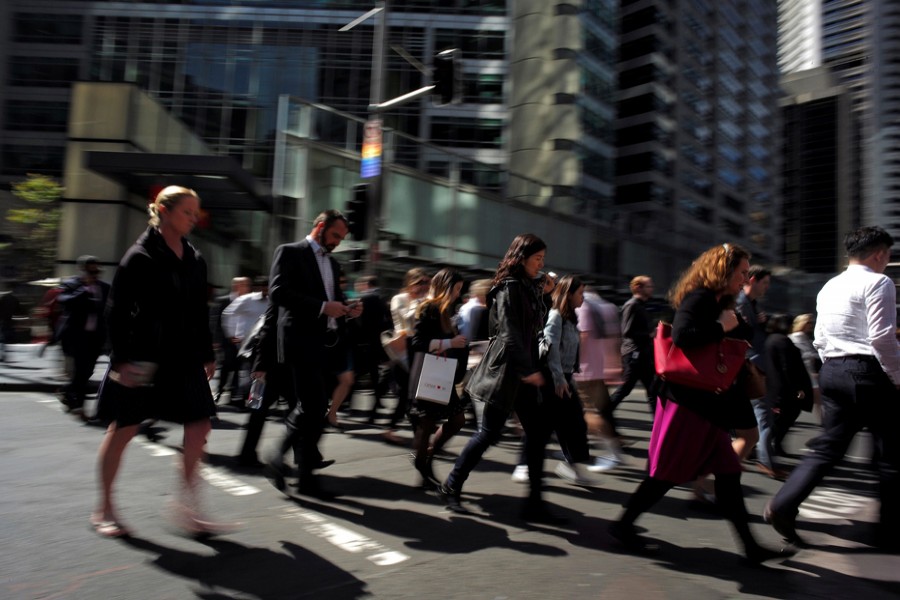 Office workers and shoppers walk through Sydney's central business district in Australia. — Reuters
