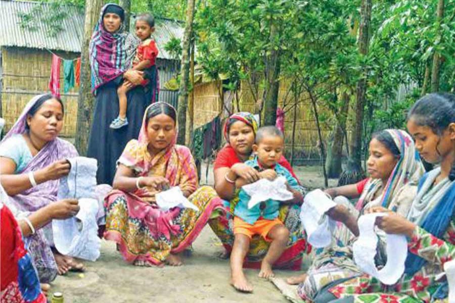 Village women make fancy caps in Alambiditor area of Gangachara upazila of Rangpur. The photo was taken on Tuesday. — FE Photo