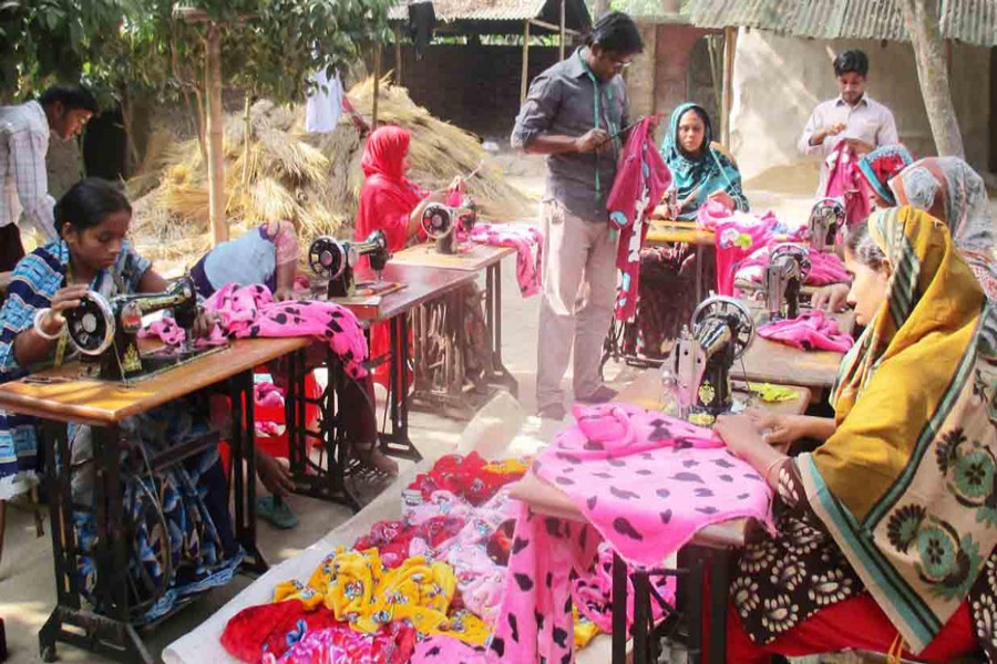 A group of female tailors are busy making clothes at Dhupchanchia upazila in Bogra on Thursday. — FE Photo