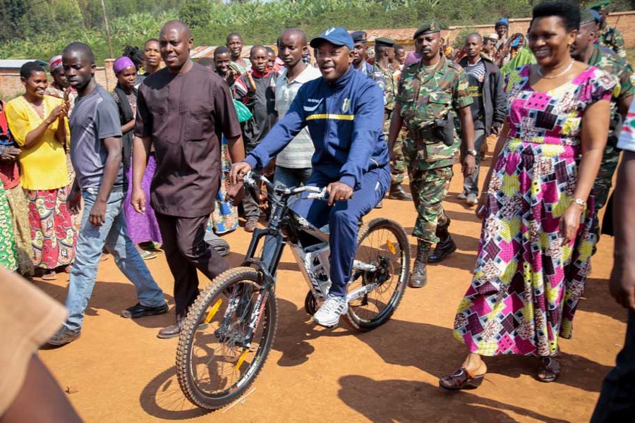 In thus file photo, president Pierre Nkurunziza, center, arrives by bicycle, accompanied by first lady Denise Bucumi Nkurunziza, right, to cast his vote for the presidential election in Burundi. - AP photo