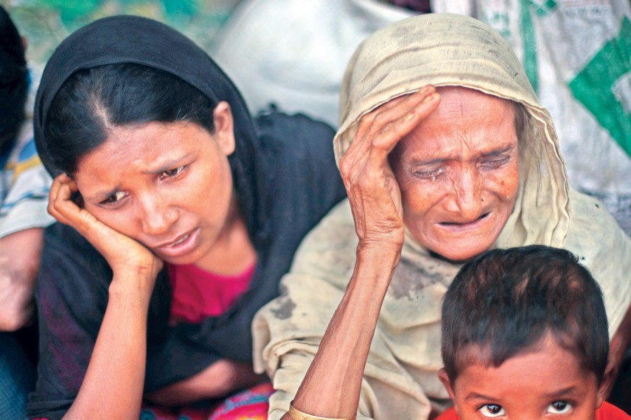 Two helpless Rohingyas, who crossed the border from Myanmar this week, burst into tears at Kutupalong refugee camp in Cox's Bazar on Friday. — Reuters