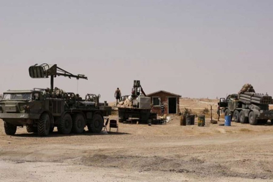 DEIR AL-ZOR: Armoured vehicles of Syrian army seen at a place of Deir al-Zor on Friday. — Reuters
