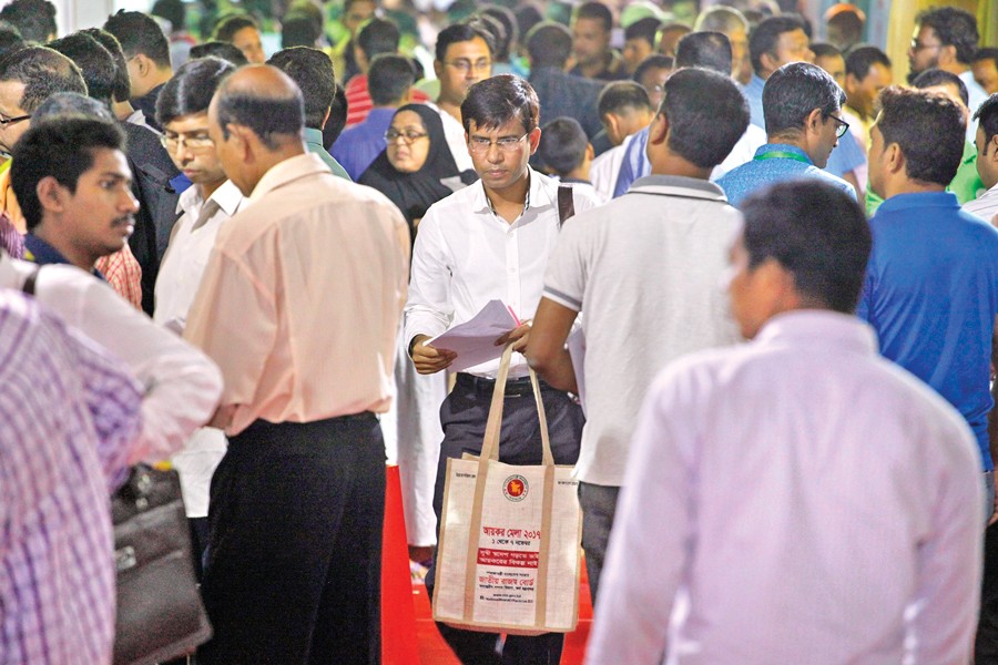 The central Tax Fair at Agargaon in the city experiences a heavy rush on Friday, a weekly holiday. A tax-payer is seen coming out of the fair after filing his tax return. — FE photo