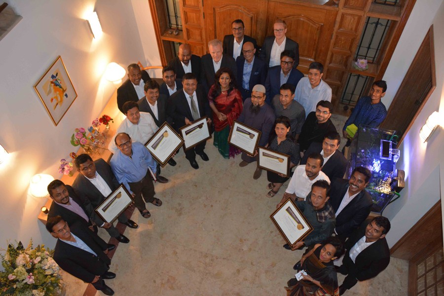 After being awarded by Novozymes, officials of eight Bangladeshi textile companies pose with Danish Ambassador Mikael Hemniti Winther in the city recently.