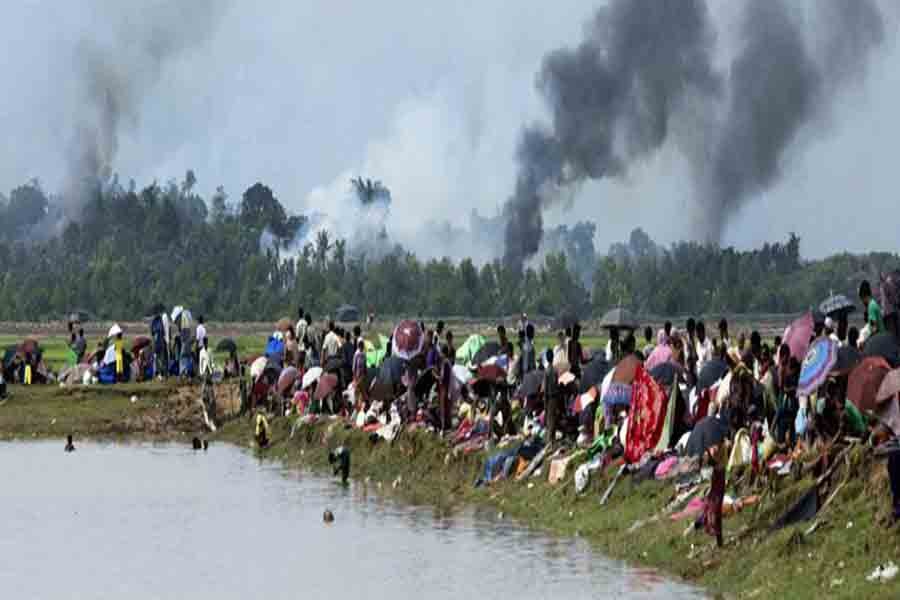 Smoke billows above what is reported to be a burning village in Myanmar's Rakhine state as members of the Rohingya Muslim minority take shelter in a no-man's land between Bangladesh and Myanmar in Ukhiya on September 04, 2017. — Photo: AFP