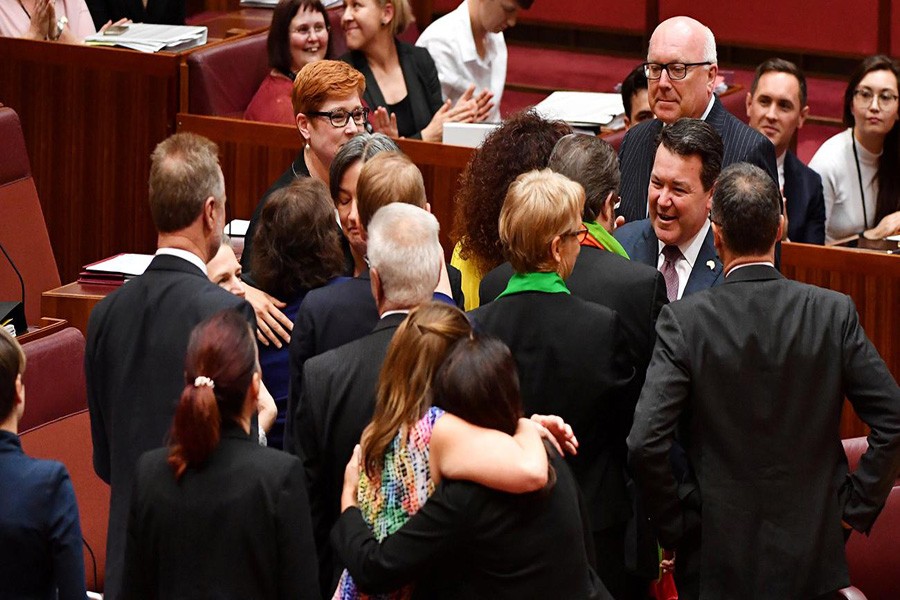 Liberal Senator Dean Smith is congratulated after the vote for the same-sex marriage bill in the Senate chamber at Parliament House in Canberra November 29, 2017. Photo: REUTERS