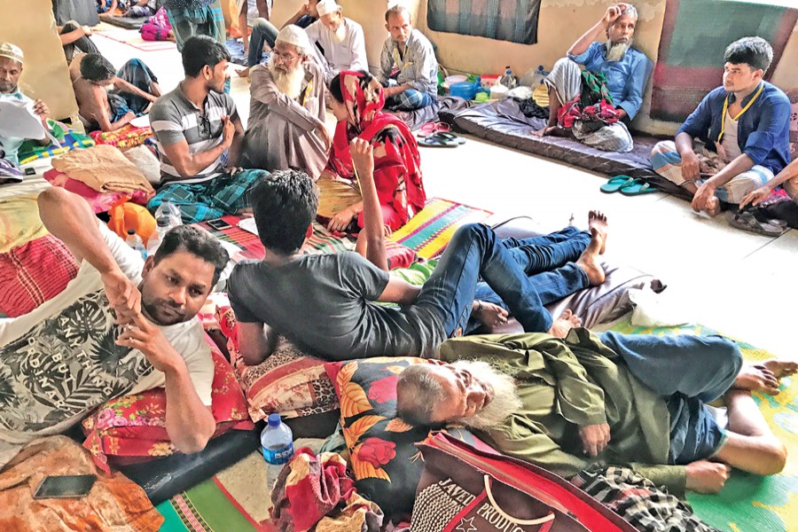 Patients along with their relatives staying on a floor at National Institute of Cardiovascular Diseases in the capital due to scarcity of beds. — FE Photo