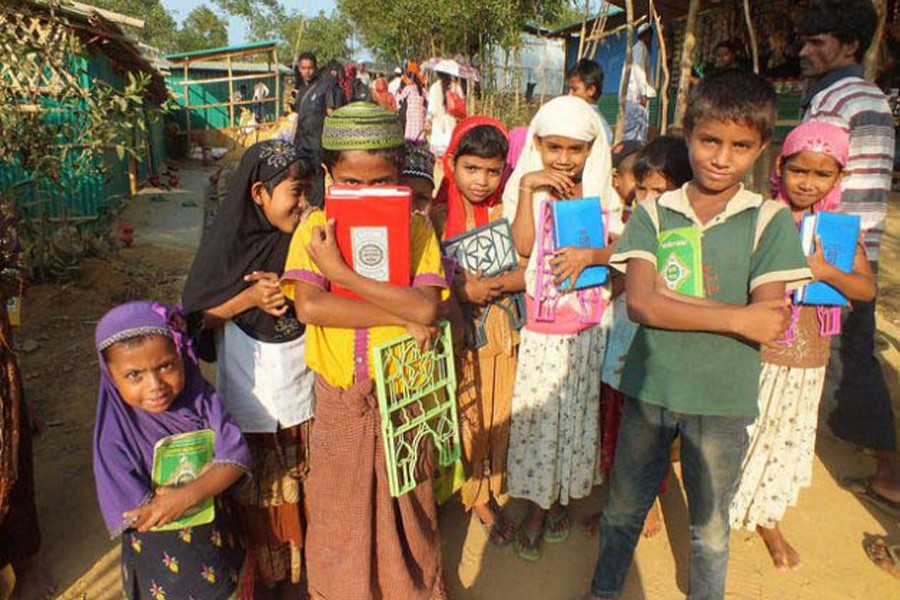 A group of Rohingya children emerge from a nearby religious school in Kutupalong camp. Photo: Naimul Haq/IPS