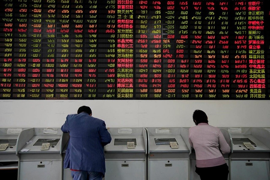 Investors look at computer screens showing stock information at a brokerage house in Shanghai, China November 24, 2017. Reuters