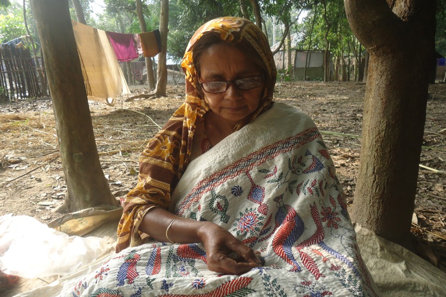 Nurjahan Begum is busy doing needlework. — FE Photo