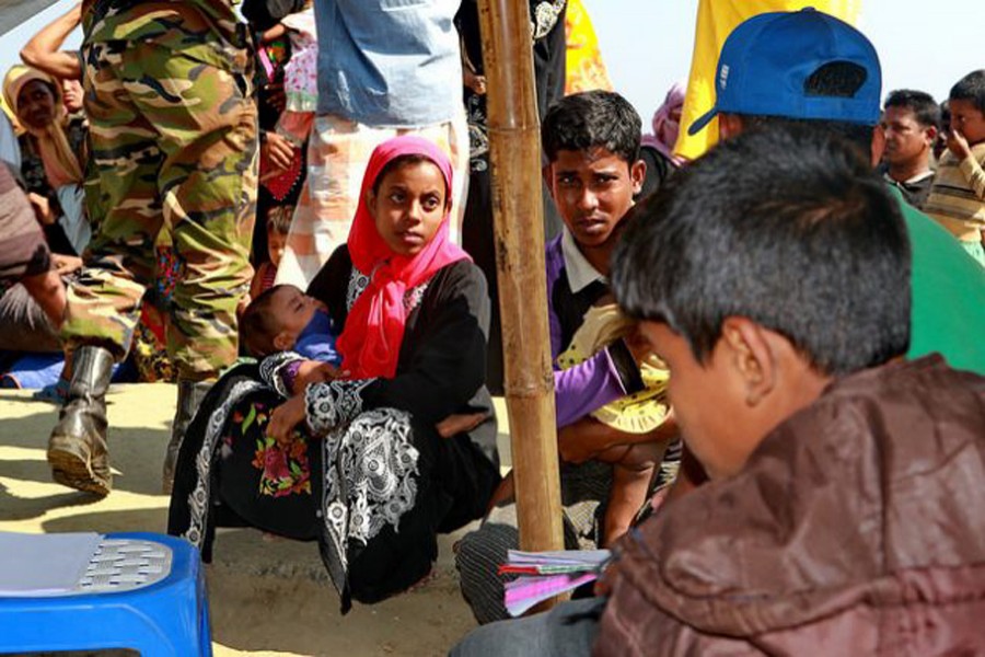 Newly-arrived Rohingya people wait at an army camp in Sabrang of Teknaf on Nov. 29 last before being shifted to a camp in Cox's Bazar. — Farid Ahmed/IPS