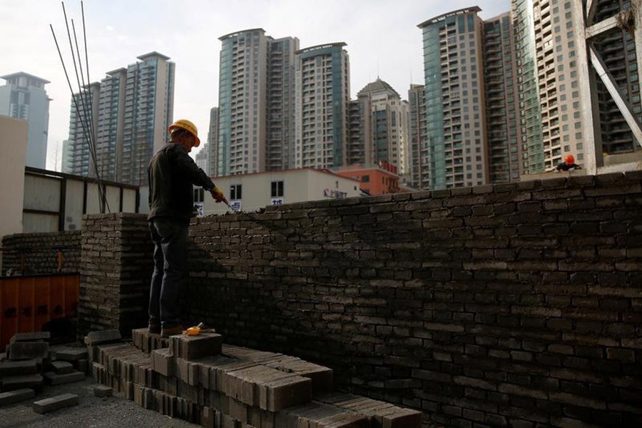 A worker works at a construction site in China on March 3, 2017. - Reuters file photo