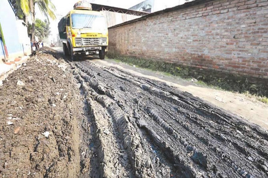 BOGRA: A miserable view of BSCIC road, causing untold sufferings to passers-by and vehicles at Fulbari under Sadar upazila of Bogra district. — FE photo