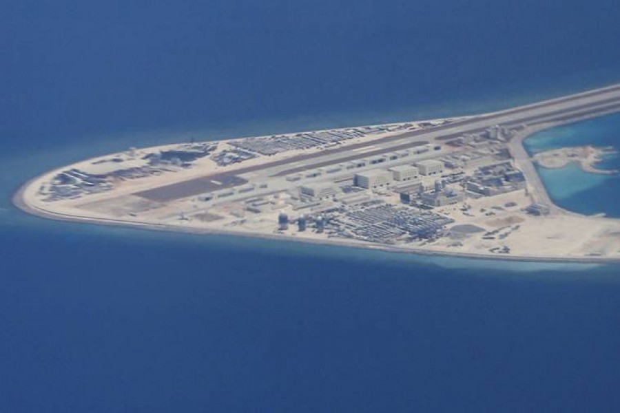 An airstrip, structures and buildings on China’s man-made Subi Reef in the Spratly chain of islands in the South China Sea are seen from a Philippine Air Force C-130 transport plane of the Philippine Air Force. - AP photo