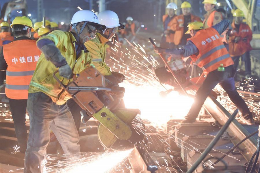 Workers work at the construction site of Longyan railway station to join three existing railways to a new railway linking Nanping and Longyan in Longyan City of southeast China's Fujian Province. — Xinhua