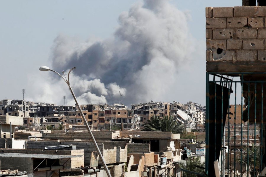 FILE - Smoke rises near a stadium where Islamic State militants were holed up, after an airstrike by coalition forces at the front line in Raqqa, Oct. 12, 2017. Photo: Voice of America
