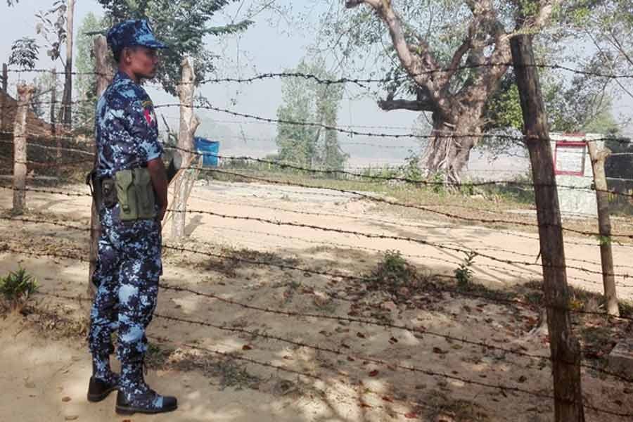 A Myanmar policeman stands outside of a camp to prepare for the repatriation of displaced Rohingyas, who fled to Bangladesh, outside Maungdaw in the state of Rakhine, Myanmar, Jan 24, 2018. Reuters