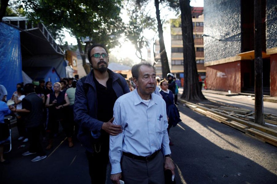 People react after an earthquake shook buildings in Mexico City, Mexico February 16, 2018. (REUTERS)