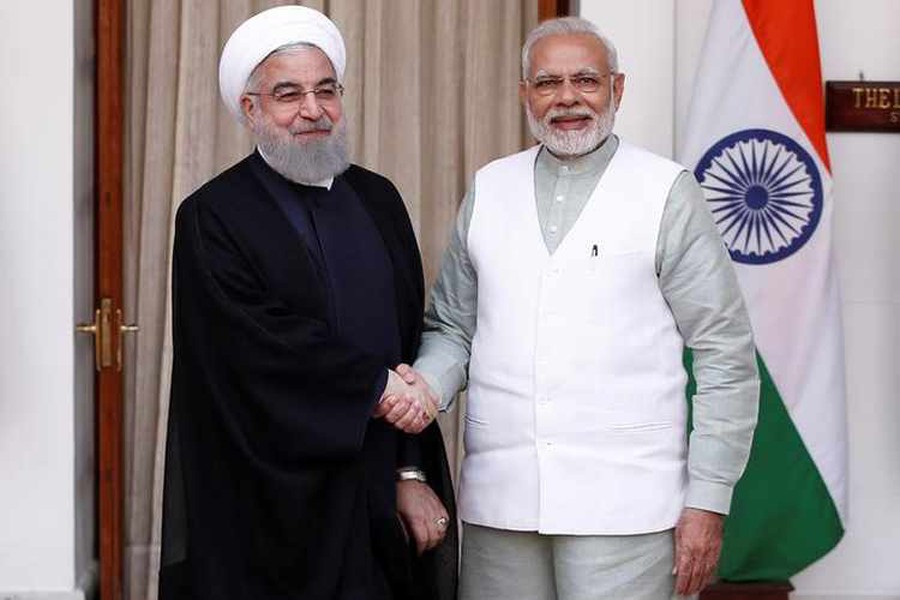 Iranian President Hassan Rouhani shakes hands with India's Prime Minister Narendra Modi (R) during a photo opportunity before their meeting at Hyderabad House in New Delhi, India Saturday. — Reuters