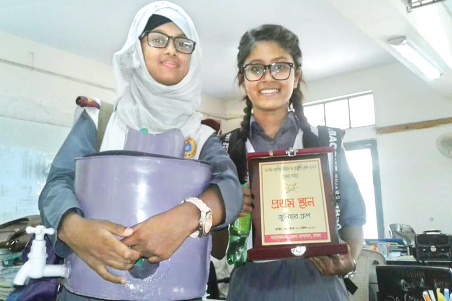 Students with an award in a recently organised science fair at Dhaka College