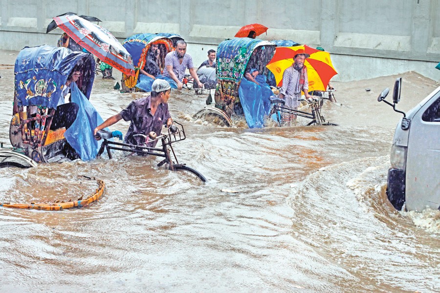 Rickshaws moving through a waterlogged road in the Motijheel area of the city during the last rainy season — FE file photo