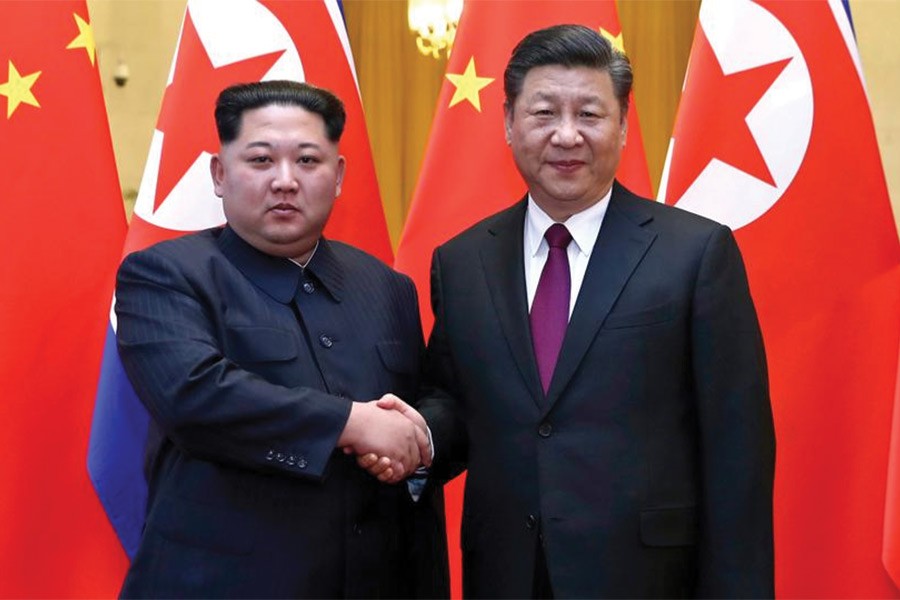 In this photo provided Wednesday, March 28, 2018, by China's Xinhua News Agency, North Korean leader Kim Jong-un, left, and Chinese President Xi Jinping shake hands in Beijing, China. — Photo: AP