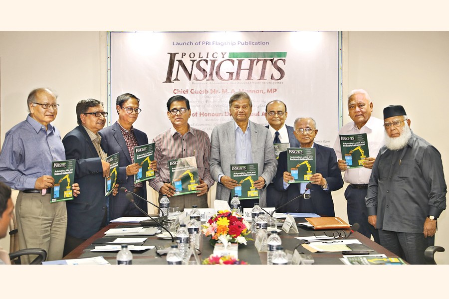 State Minister for Finance and Planning M A Mannan along with other dignitaries holding the copies of Policy Insights, a new publication of Policy Research Institute of Bangladesh (PRI), at its launching ceremony in the capital on Monday — FE Photo