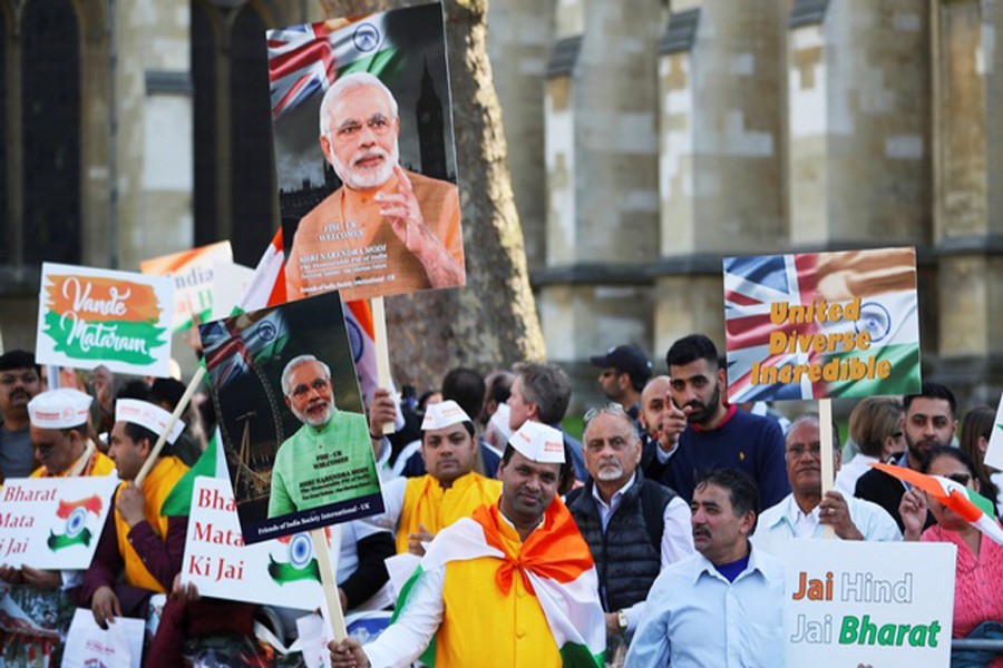 Demonstrators holding placards and pictures of India's Prime Minister Narendra Modi at Parliament Square in London on Wednesday — Reuters