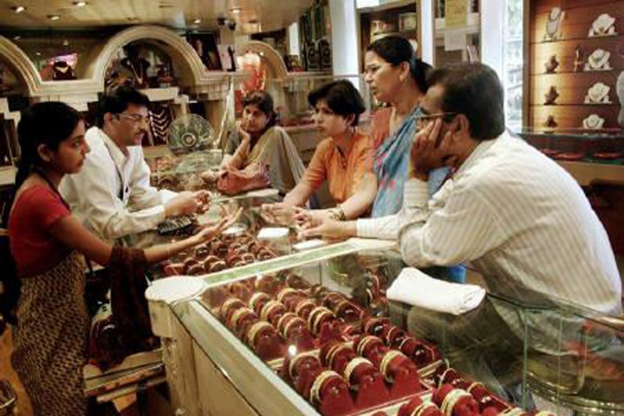 Customers looking at gold bangles in a jewellery shop in Mumbai — Reuters