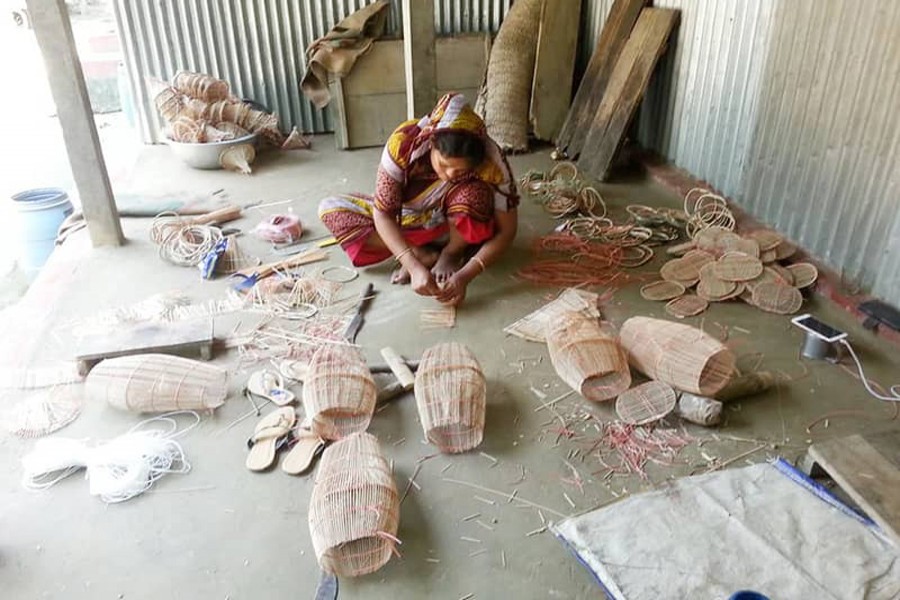 A woman making bamboo fishing gears in Faridpur on Monday — UNB Photo