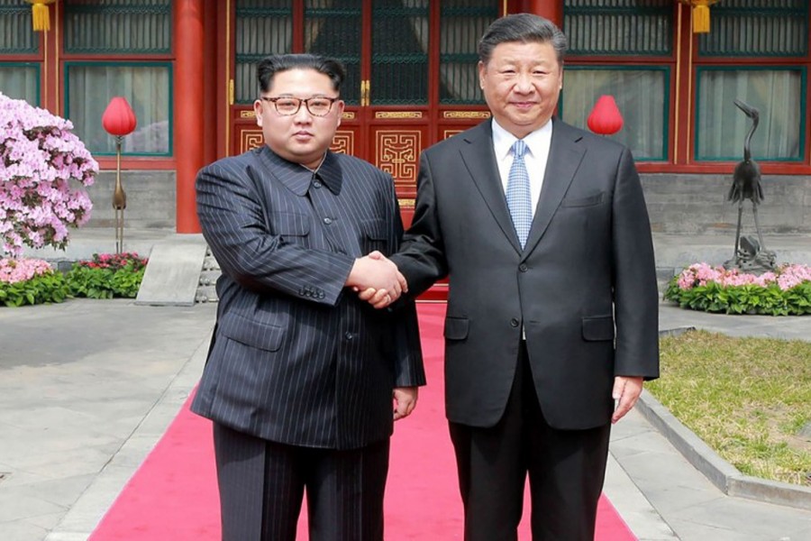 North Korean leader Kim Jong Un shaking hands with Chinese President Xi Jinping during a meeting in Beijing recently — Reuters