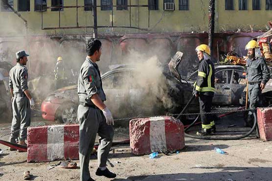 Afghan policemen inspecting the site of a suicide bomb blast in Jalalabad on Monday — BBC