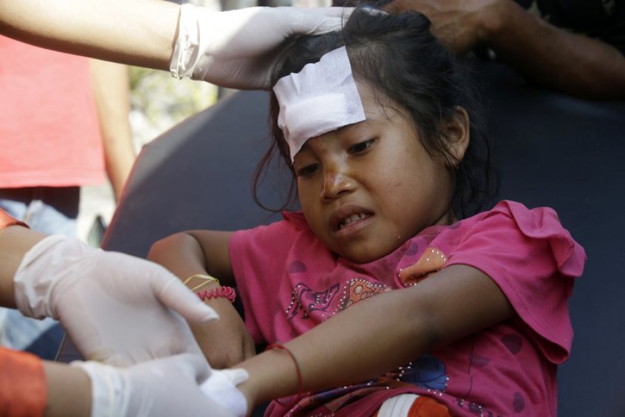 A girl injured in an earthquake is treated in Mataram, Lombok, Indonesia, Thursday, Aug. 9, 2018. The Indonesian island of Lombok was shaken by a third big earthquake in little more than a week Thursday. - AP Photo
