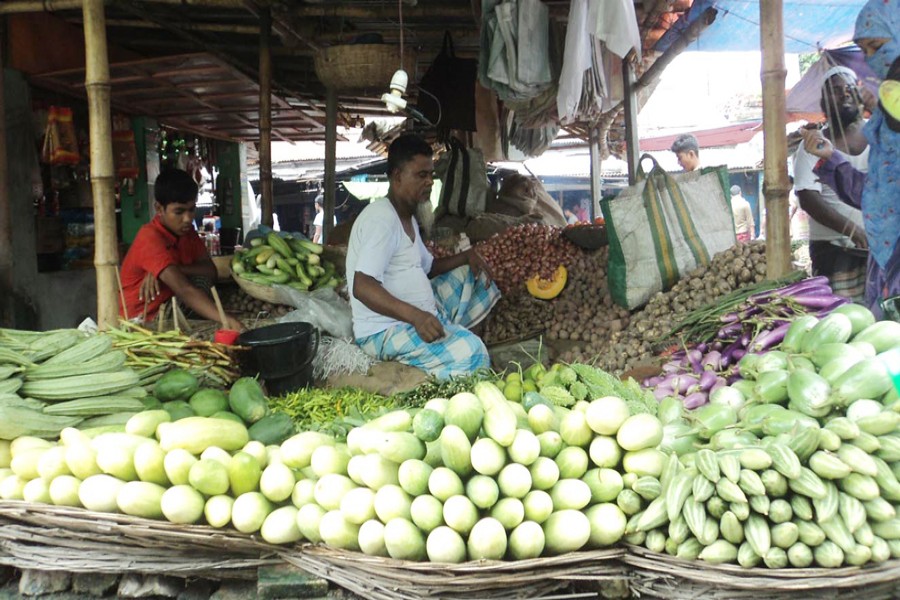 A seller waiting for customers at his vegetable shop in Khojanpur Kitchen Market under Joypurhat Sadar on Monday — FE Photo
