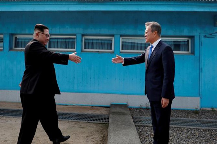 A file photo showing Kim Jong-un and Moon Jae-in — Reuters