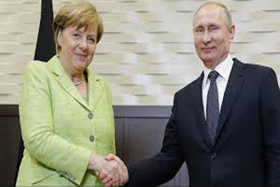 A file photo showing German Chancellor Angela Merkel shaking hands with Russian President Vladimir Putin recently — Reuters