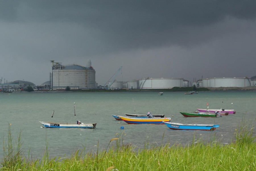 Dark clouds pull up over an oil storage terminal in Johor, Malaysia — Reuters