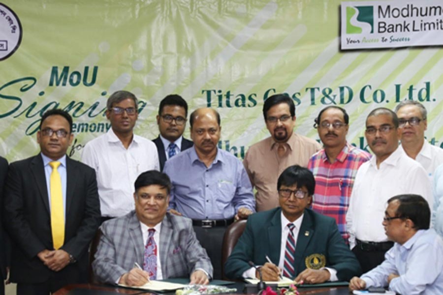 Modhumoti Bank Limited Managing Director and chief executive officer Shafiul Azam and Titas Gas Transmission & Distribution Company Ltd Company Secretary Abdul Hakim Mukta signing a deal in Dhaka city recently