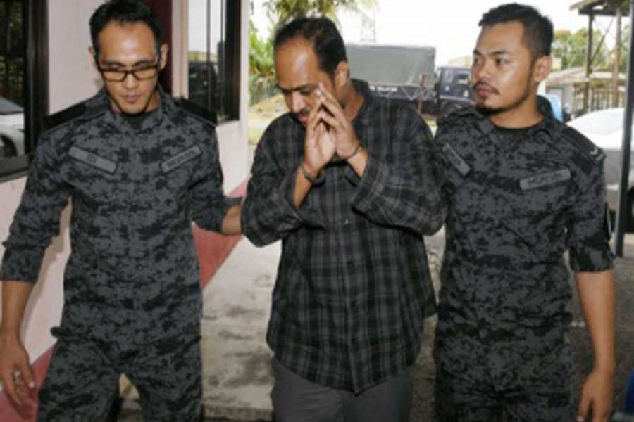 Bangladeshi labourer Md Mohiuddin Mamun, 40, (C) was sentenced to six years and eight months' jail, as well as a fine of RM30,000, in default six months' jail, and two strokes of the cane by the Immigration sessions court in Pekan Nanas on Monday — Bernama