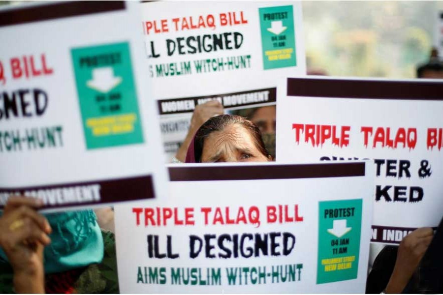Muslim women hold placards during a protest against a bill passed by India's lower house of Parliament last week that aims at prosecuting Muslim men who divorce their wives through the "triple talaq," or instant divorce, in New Delhi, India Jan 4, 2018. - Reuters