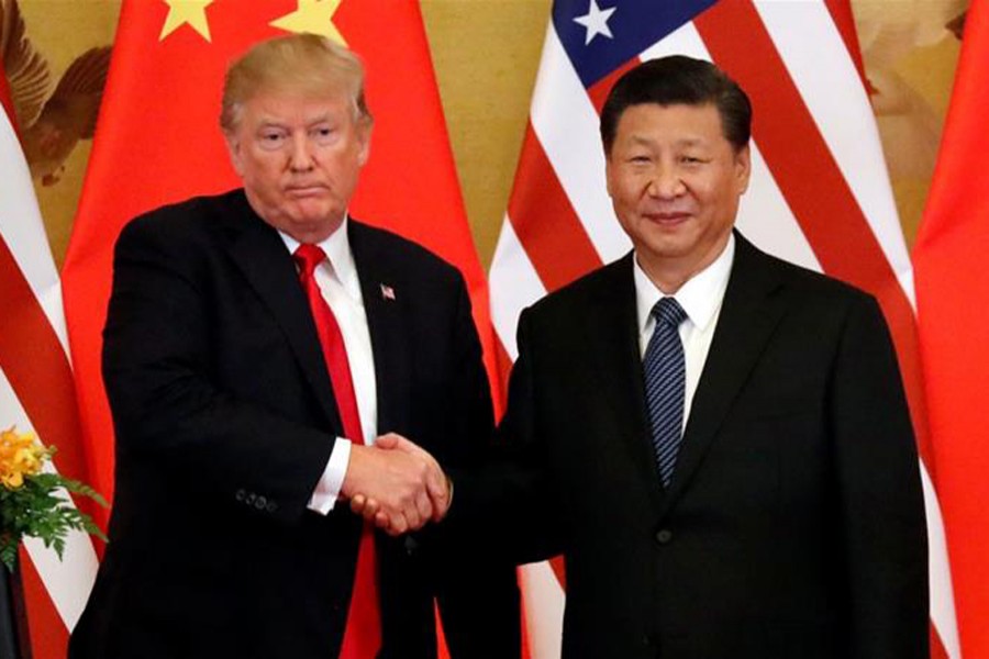 A file photo showing US President Donald Trump shaking hands with China’s President Xi Jinping during a meeting recently — Reuters