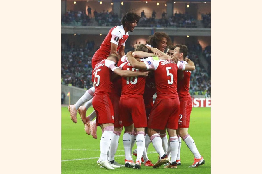 Arsenal's players celebrating after scoring the opening goal during a Group E Europa League match against Qarabag FK at the Olympic stadium at Baku in Azerbaijan on Thursday — AP