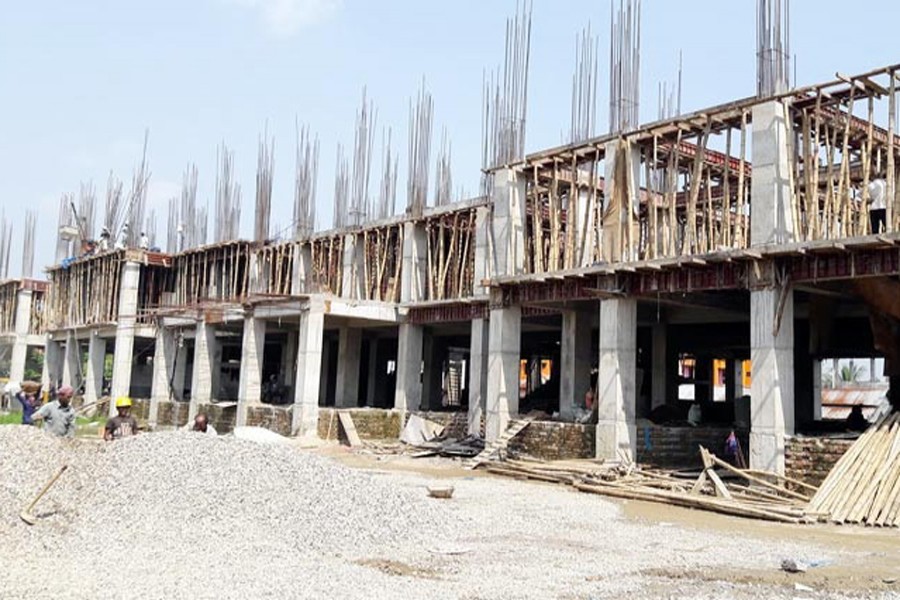 Labourers working at the construction site of the 10-storey building for the Chief Judicial Magistrate Court in Sunamganj on Sunday — FE Photo