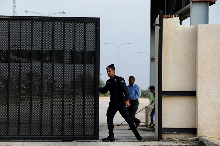 A Jordanian policeman opening the gate of Jordan's Jaber border crossing checkpoint near Syria's Nasib checkpoint, near Marfaq, Jordan on Monday — Reuters