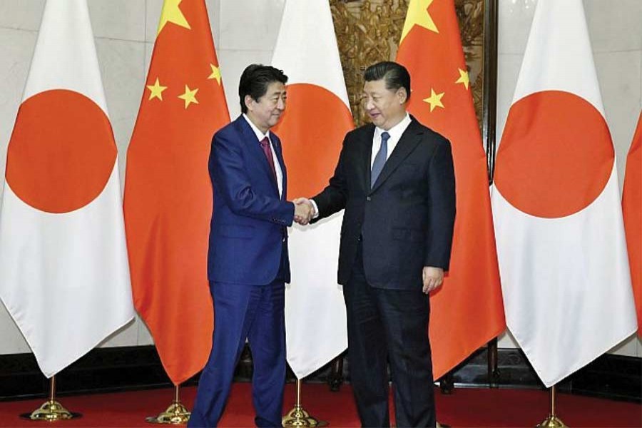 President Xi Jinping and Prime Minister Abe greet each other in Beijing on October 26, 2018: "Abe's Beijing visit, first of all, implicitly acknowledges China's ascendancy. That is the only reason why China is willing to put the East China Sea disputes on the back-burner". —Photo; Reuters