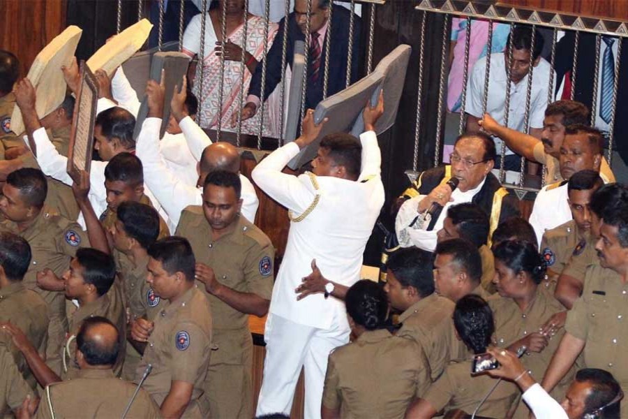 A Parliament Member, who is backing newly appointed Prime Minister Mahinda Rajapaksa, throws a chair at police who are there to protect parliament speaker Karu Jayasuriya (not pictured) during a parliament session in Colombo, Sri Lanka on November 16, 2018. —Photo: Reuters